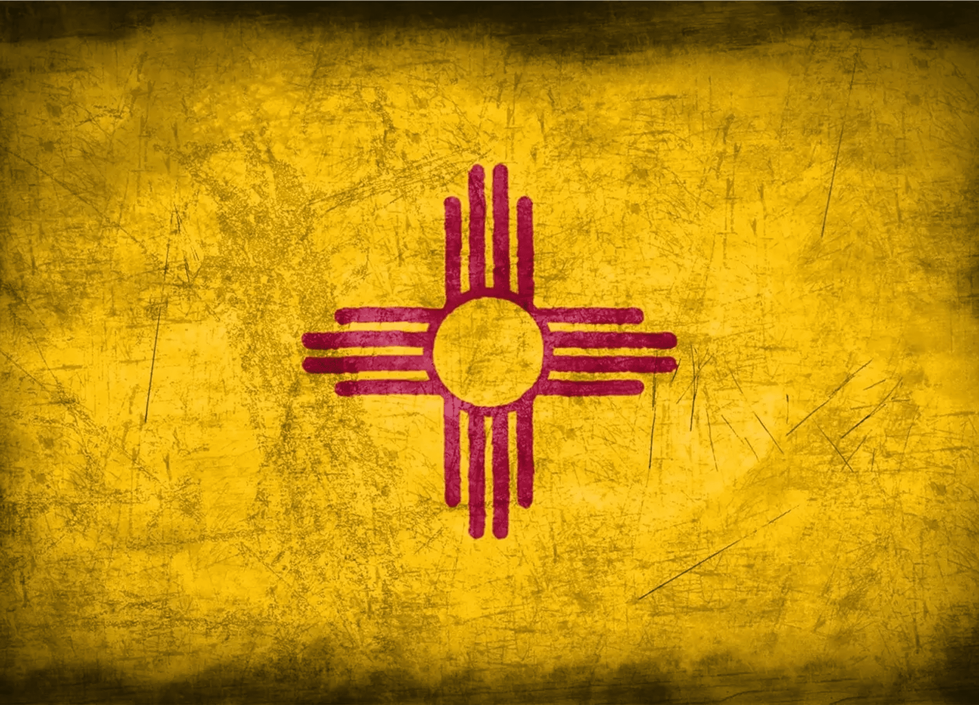 Yellow flag with red Zia symbol.