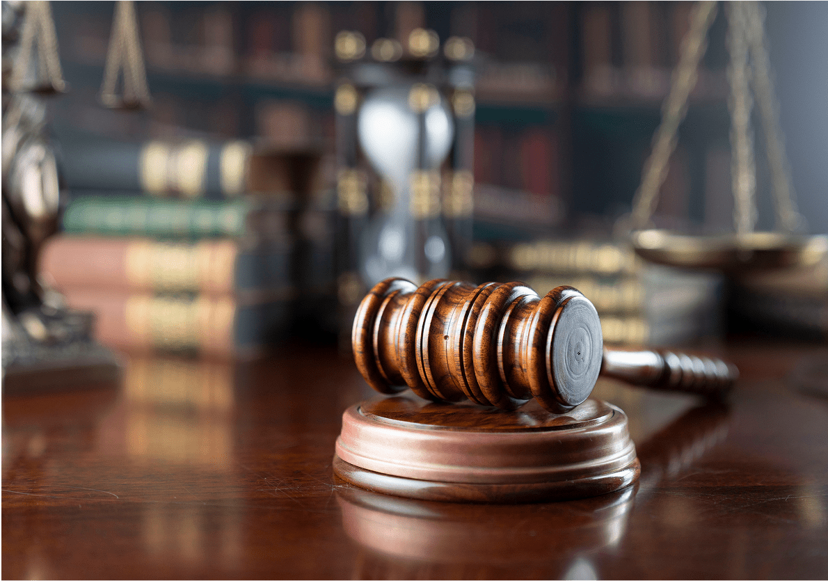 Gavel on a judge's desk with books.